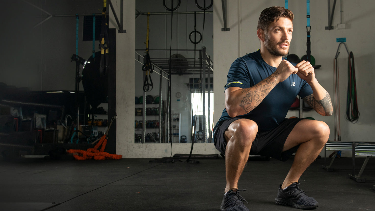 Luke Zocchi performs a bodyweight squat.