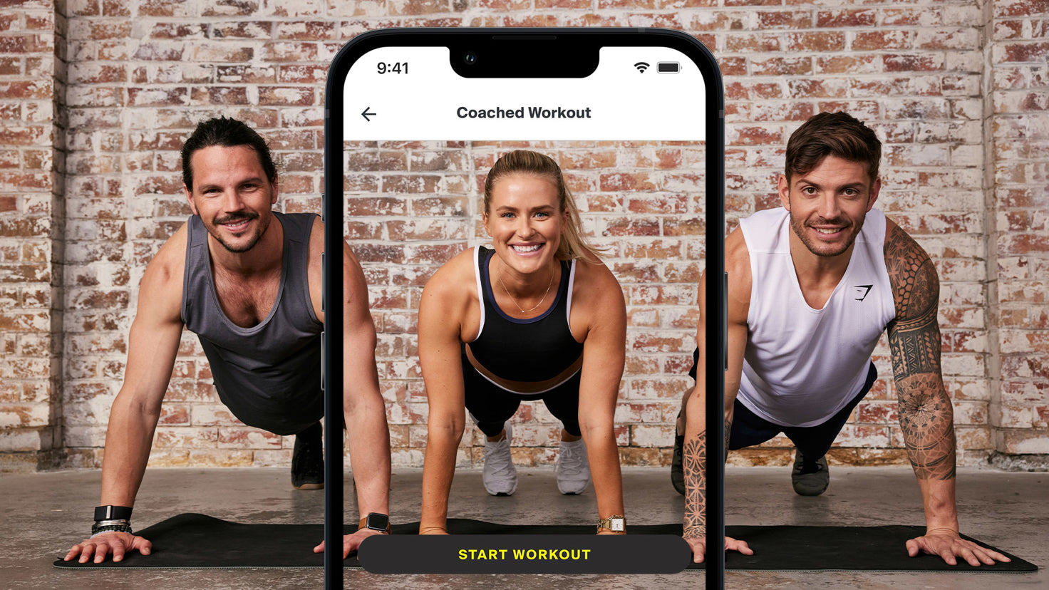 Two men and one woman wearing workout clothes with their hands in the air.