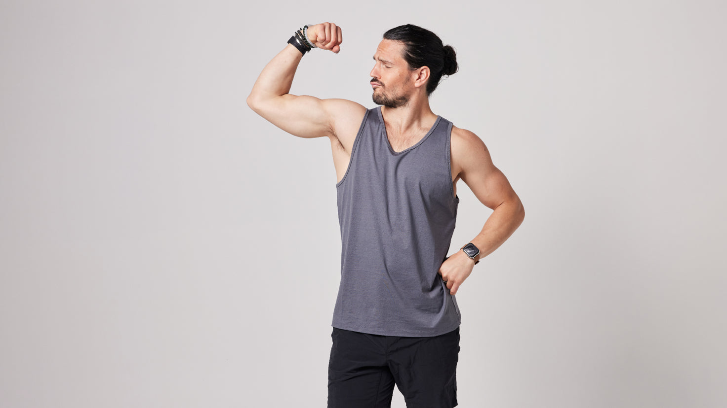 Dan Churchill looks admiringly at his flexed right bicep.