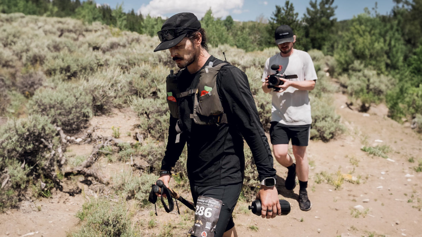An injured Dan Churchill walks back on the Leadville trail with his eyes downcast.