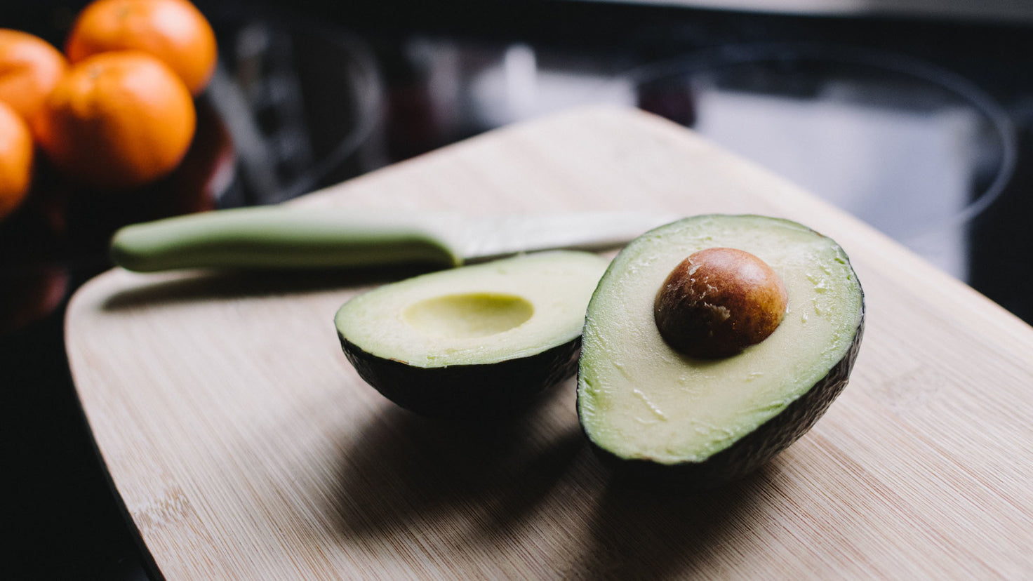 An avocado, sliced in half.