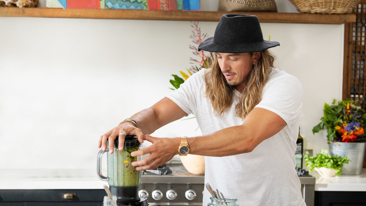 Simon Hill blends a healthy green smoothie in the kitchen.