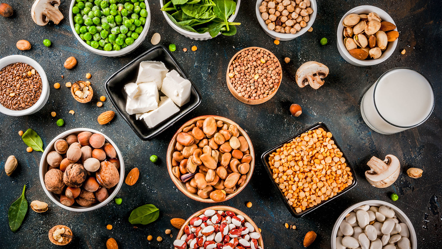 Flat lay of grains and legumes like peas, broad beans and lentils.