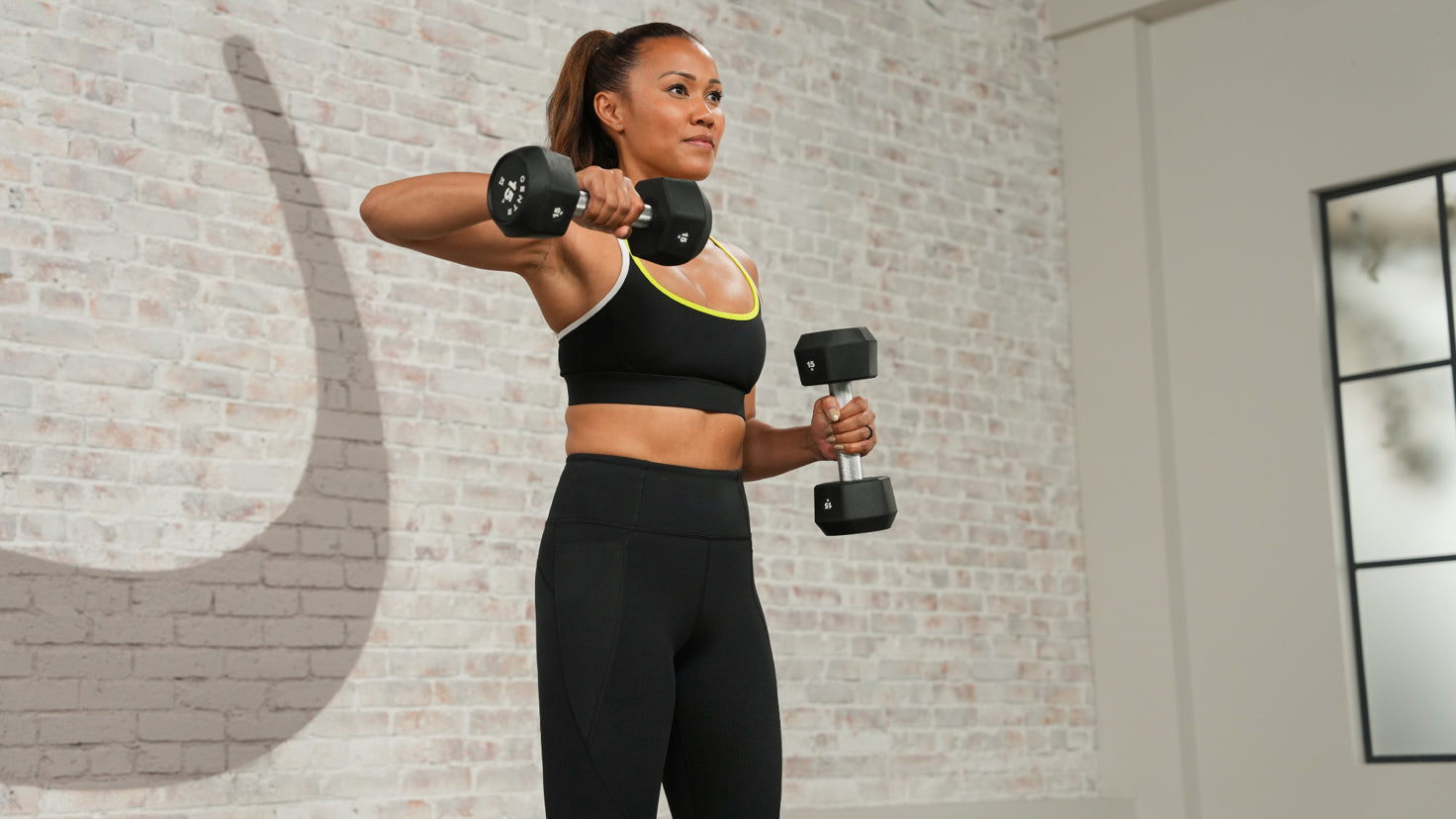 Centr trainer Maricris Lapaix performs an upper-body workout using dumbbells.