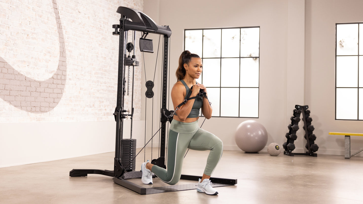 Centr trainer Maricris Lapaix performs a cable forward lunge using the Centr 1 Home Gym machine.