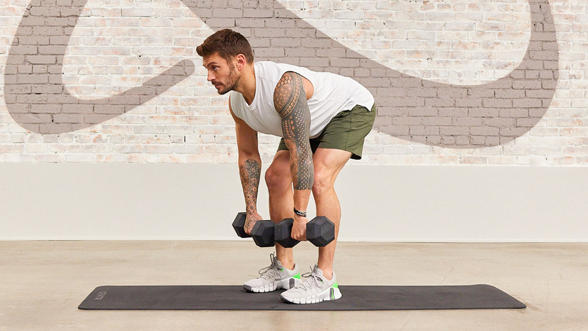 Luke Zocchi performs a dumbbell Romanian deadlift in the Centr studio gym.