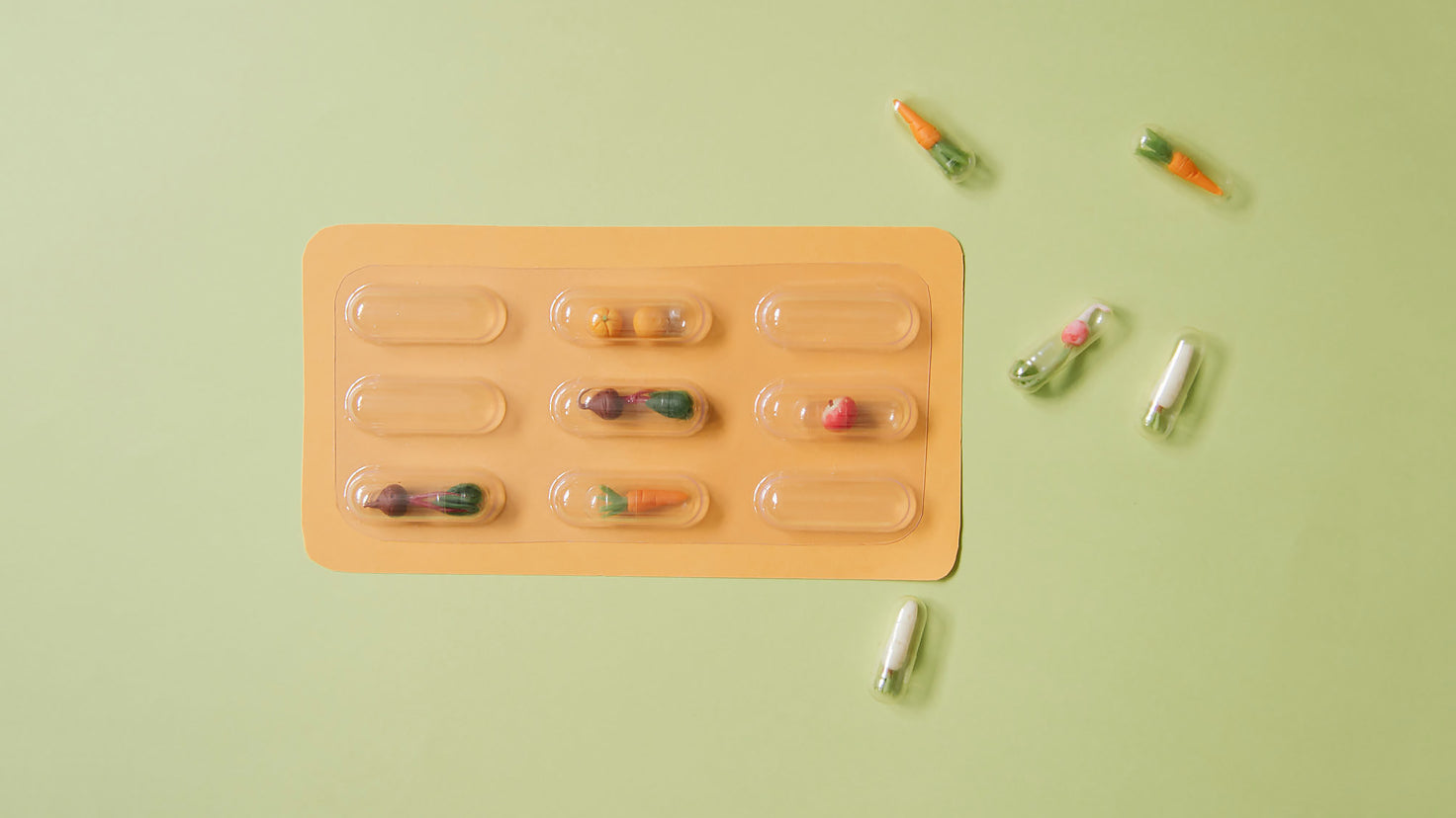 Minature clay vegetables displayed in pharmaceutical bubble packs.