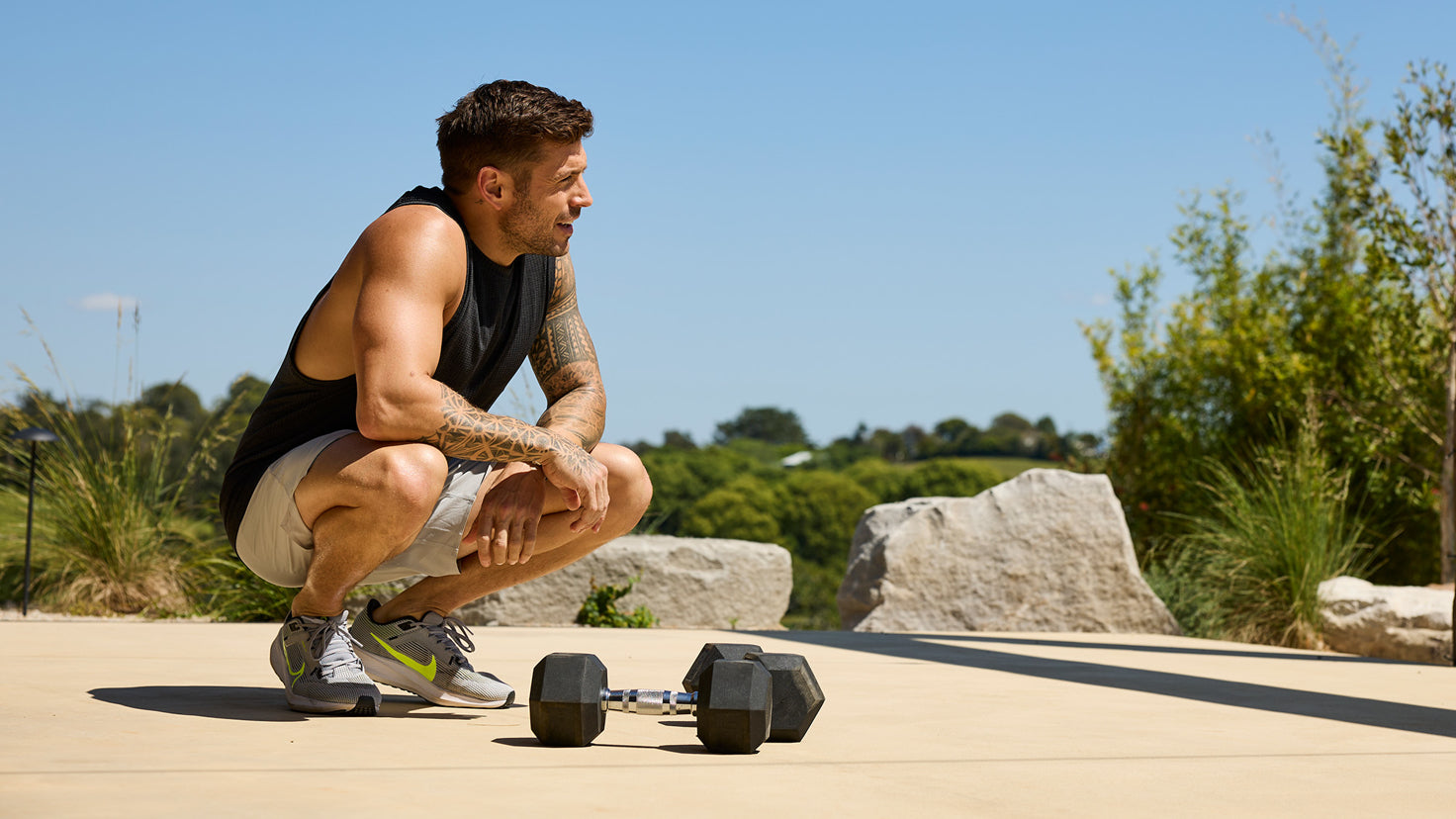 Centr Trainer Ingrid Clay performs a dumbbell lunge with the Centr SmartStack dumbbells.