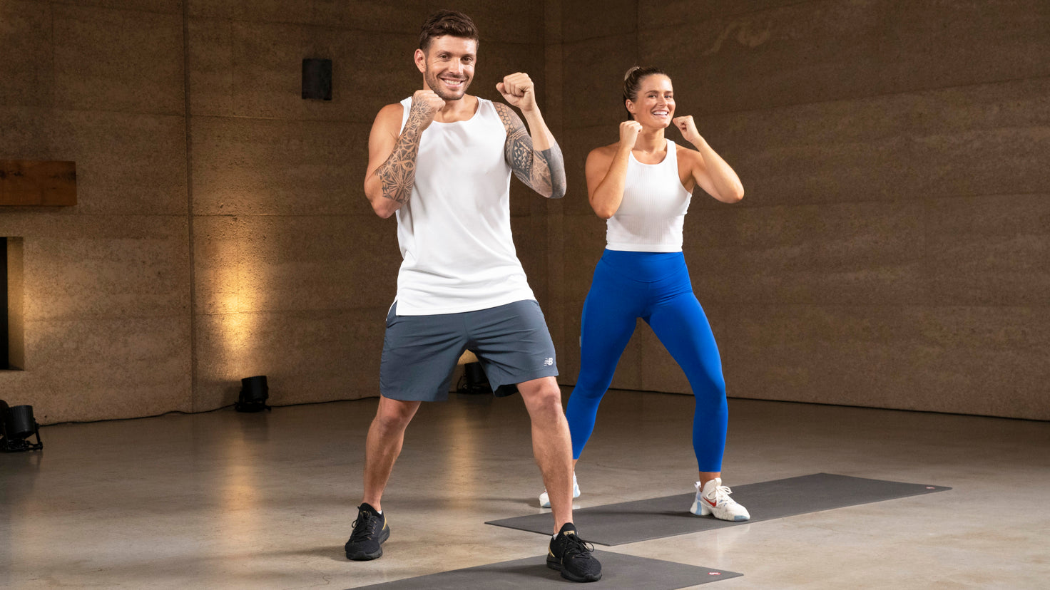 Luke Zocchi demonstrates a high-impact jump squat, while Ashley Joi demonstrates a low-impact squat.