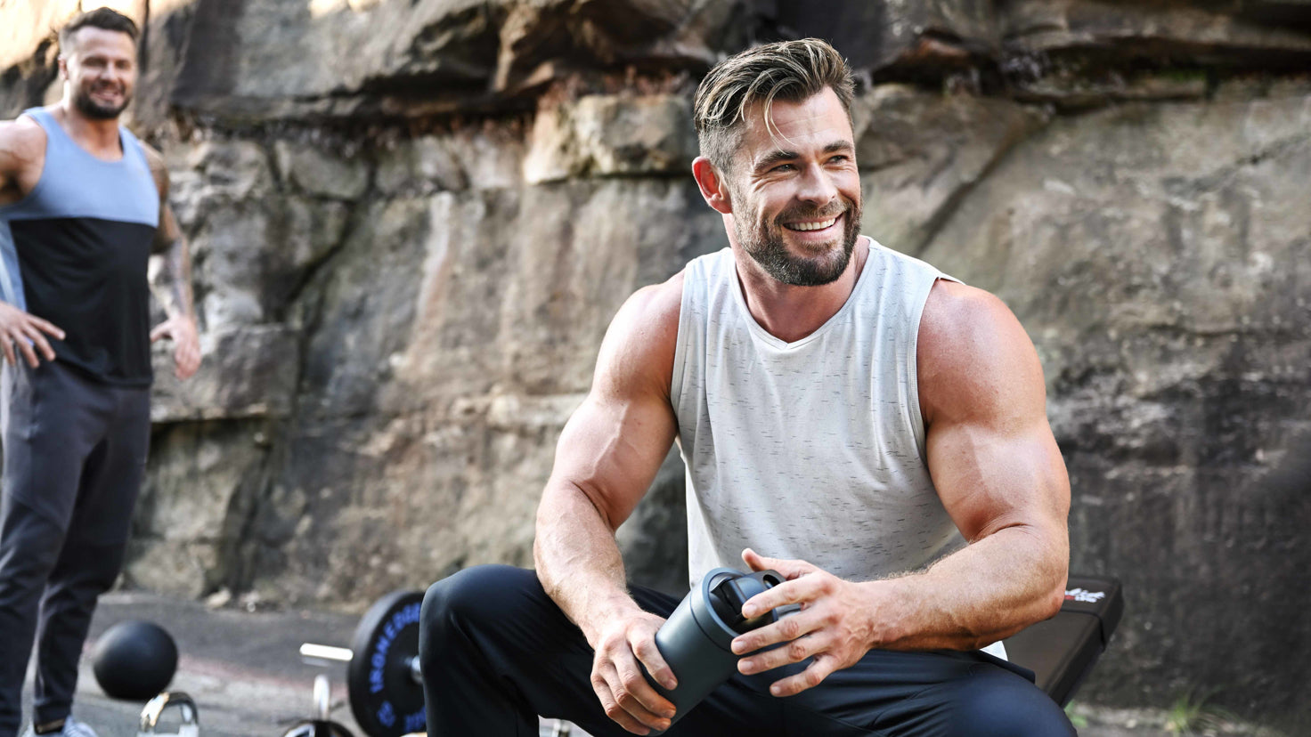 Chris Hemsworth smiling, looking away from the camera.