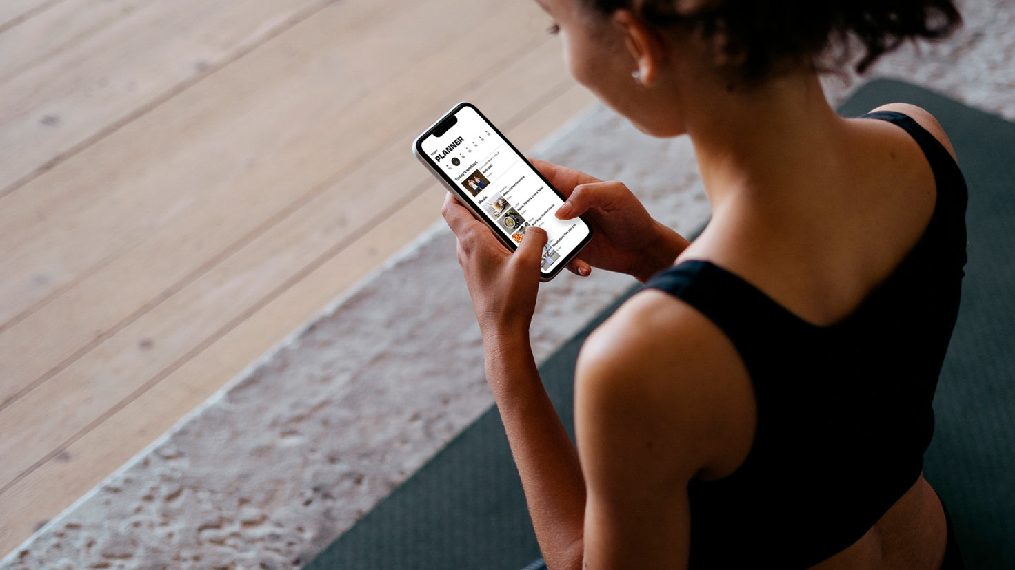 A woman uses the meal swap function on the Centr app to plan dinner.