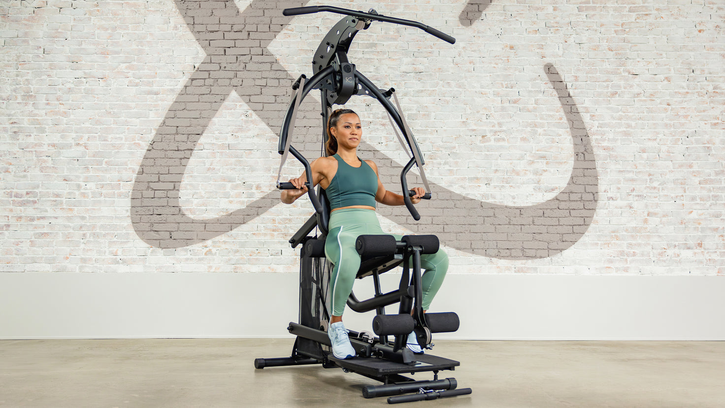 Centr trainer Maricris working out on the Centr Body Weight machine.