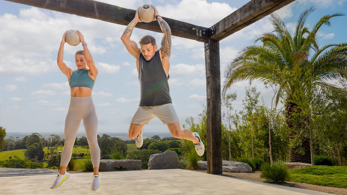 Centr trainers Alexz Parvi and Luke Zocchi jump high in the air with slam balls.