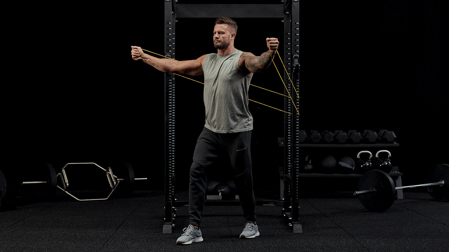 Bobby Holland Hanton uses a resistance band to perform chest exercises.