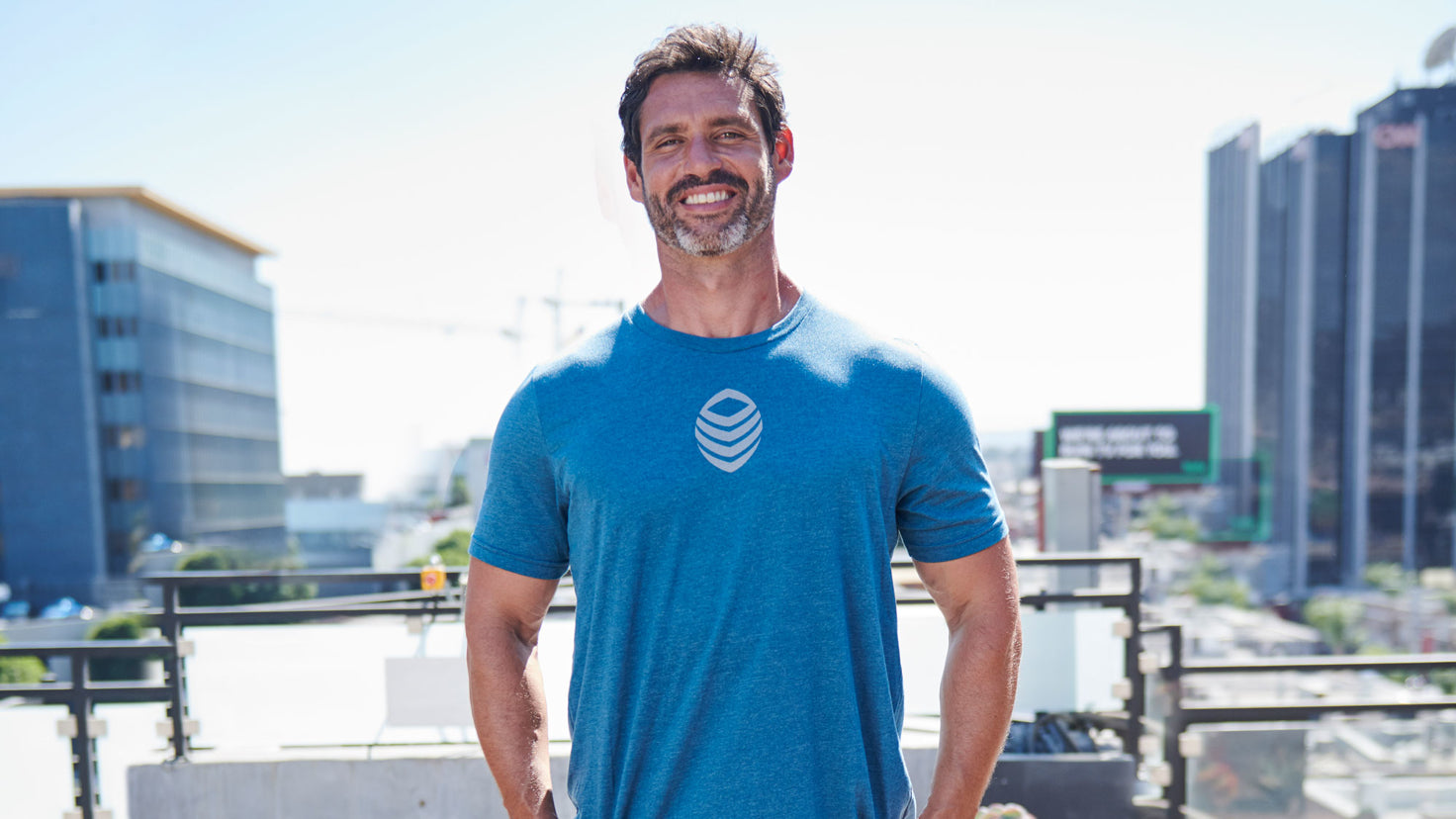 Dr. Eric Goodman smiling and wearing a blue shirt.