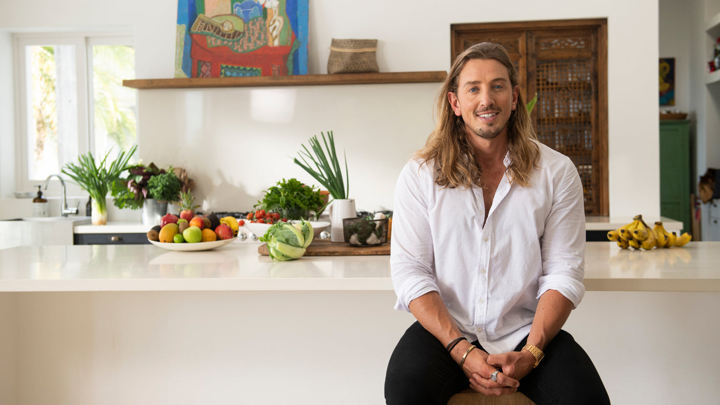Chef Simon Hill sitting in a bright kitchen.