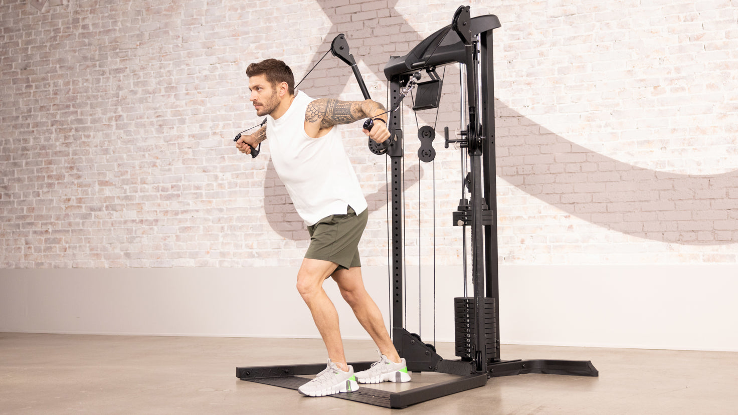 Centr trainer Luke Zocchi performs a cable decline chest fly using the Centr 1 Home Gym machine.