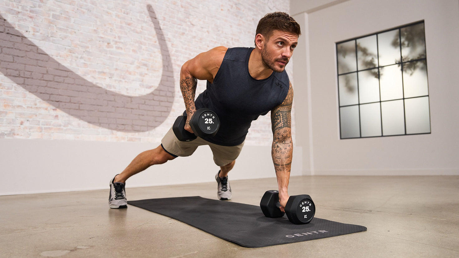 Centr trainer Luke Zocchi performing a renegade row.