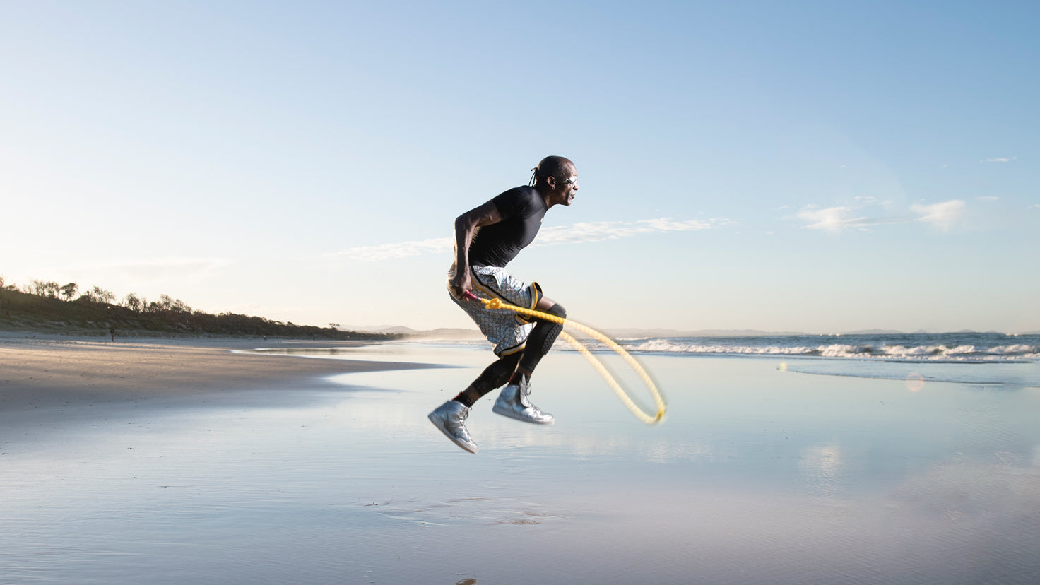 Michael Olajide Jr. jumping rope on an empty beach.