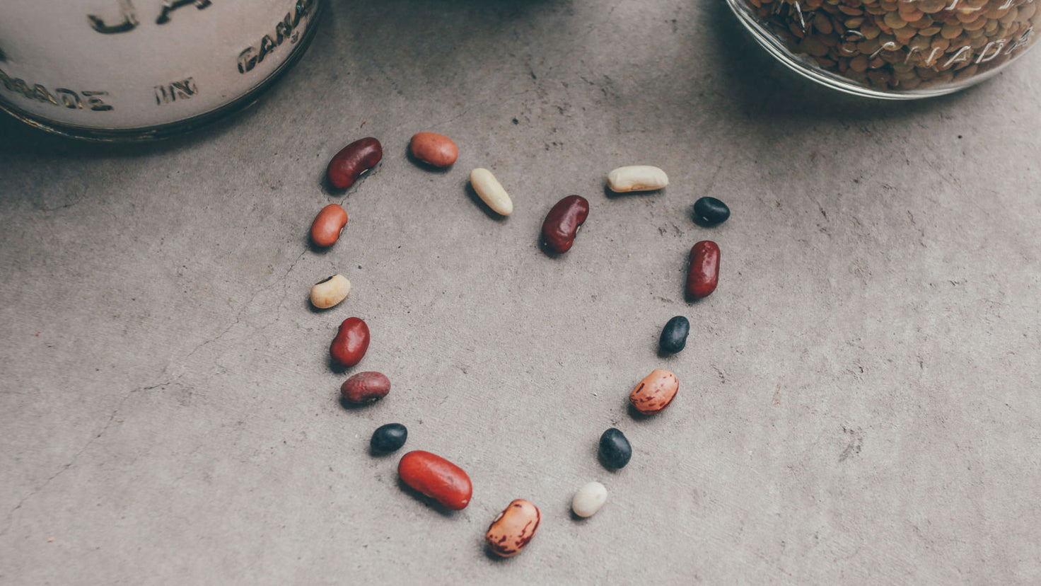 Different bean varieties laid out in the shape of a heart.