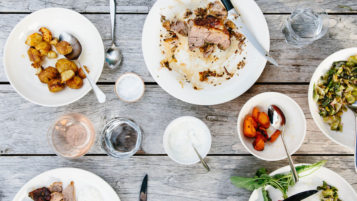 Leftover turkey and sides from a Thanksgiving meal lie on a table.