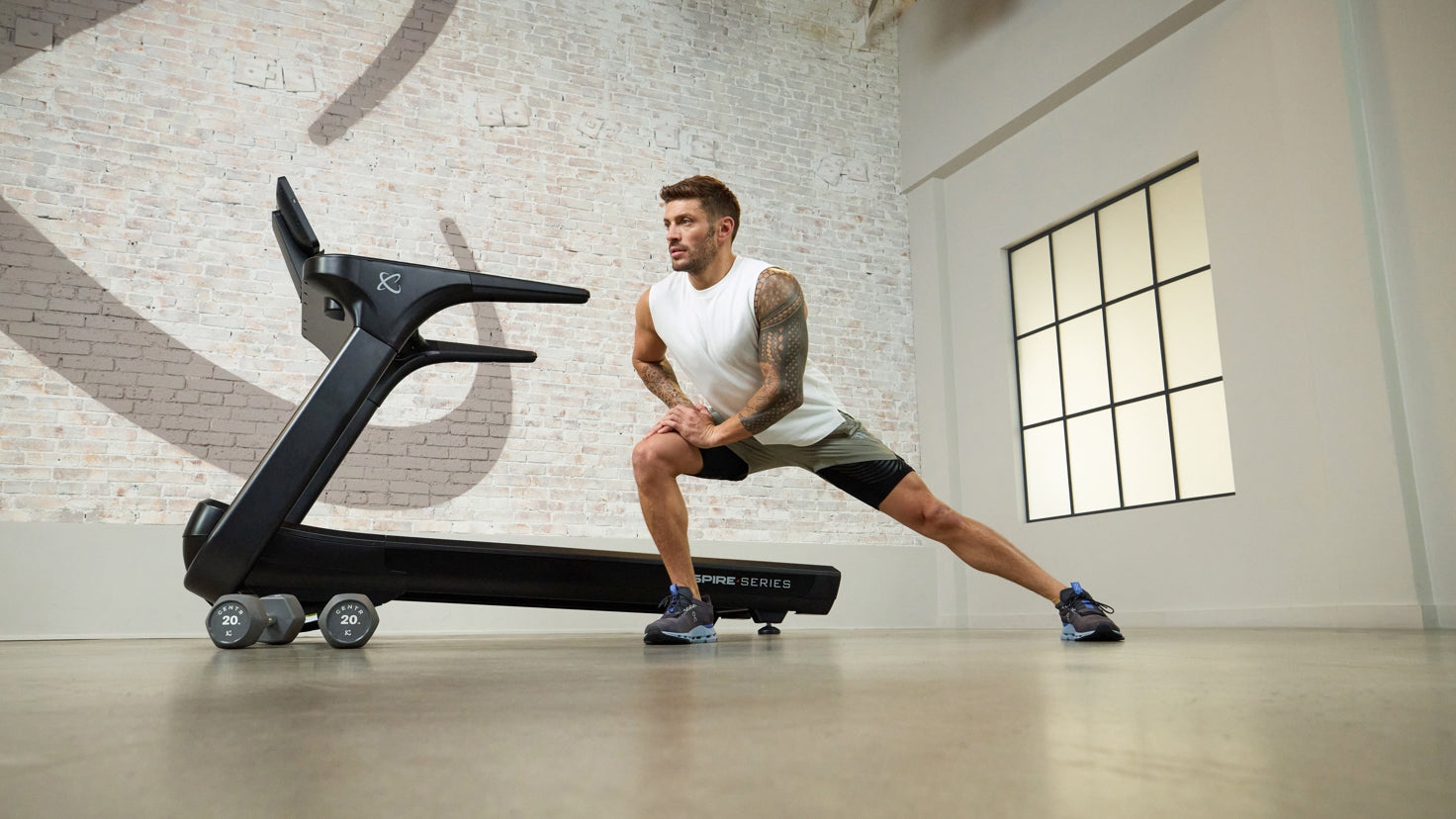 Centr trainer Macricris Lapaix runs in her home office on the Centr treadmill.