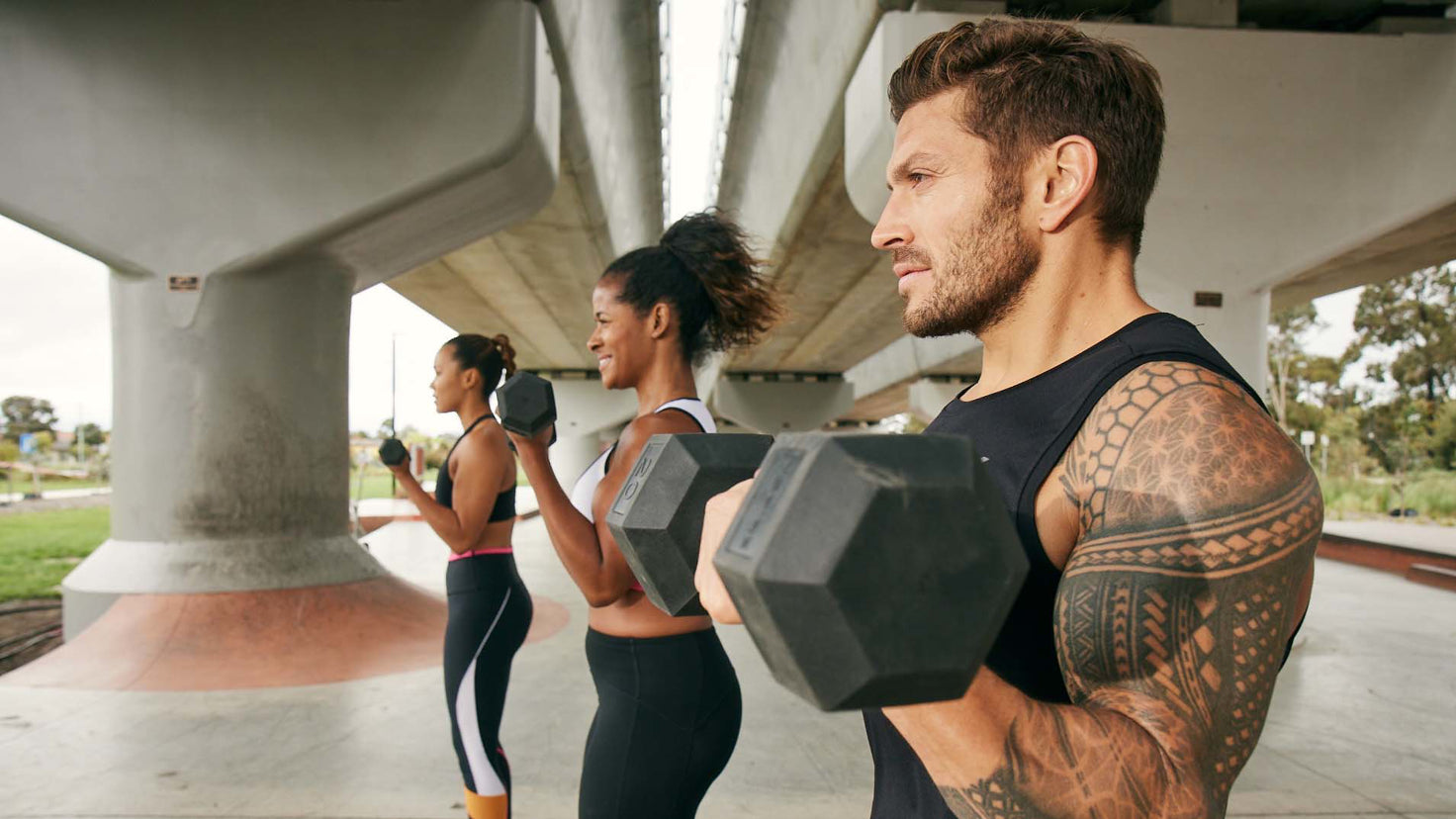 Luke Zocchi, Ingrid Clay and Maricris Lapaix lift dumbbells.
