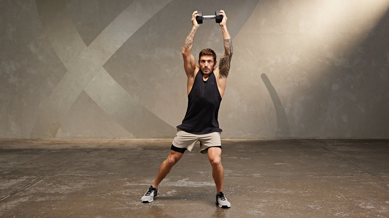 Tutorial: Dumbbell half jack steps + press - Centr